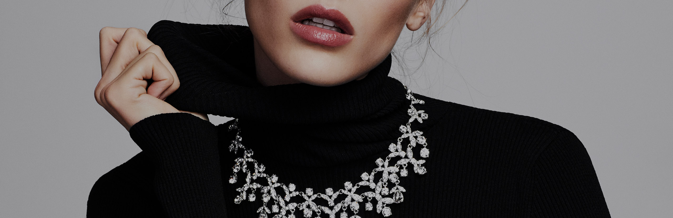 Close up photo of woman wearing Jewelry produced by The Jewelry Group